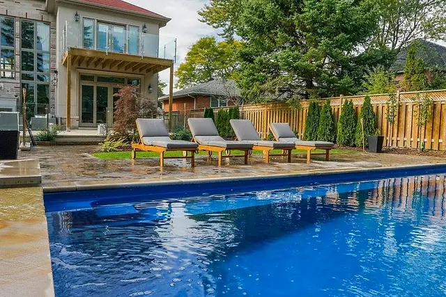 Pool and loungers on a stone patio