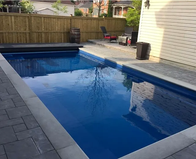 Rectangular pool with a stone patio